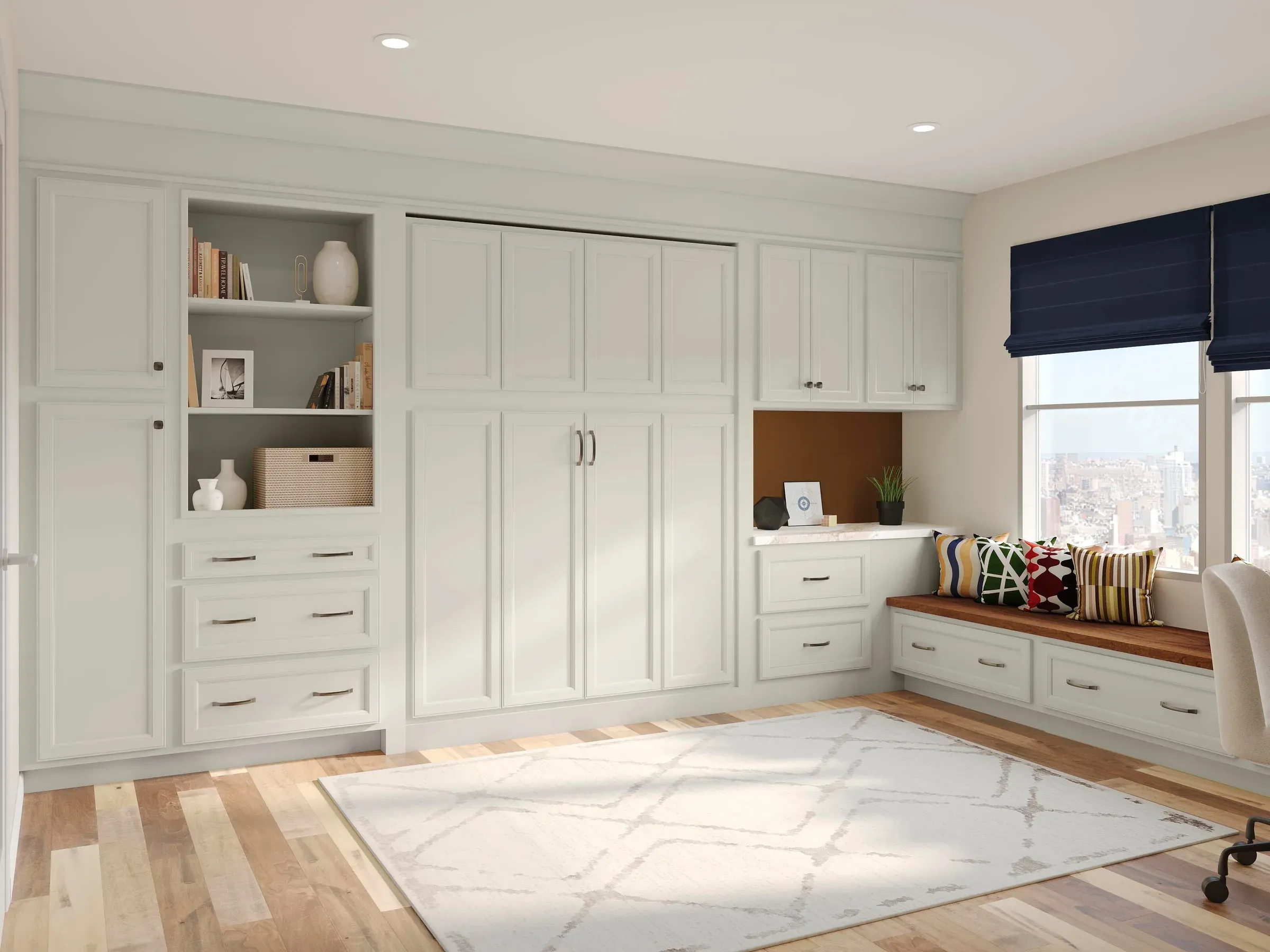 Home office wall in Duraform Harbor with a closed Murphy bed, flanking storage cabinets, and a window seat with drawers.