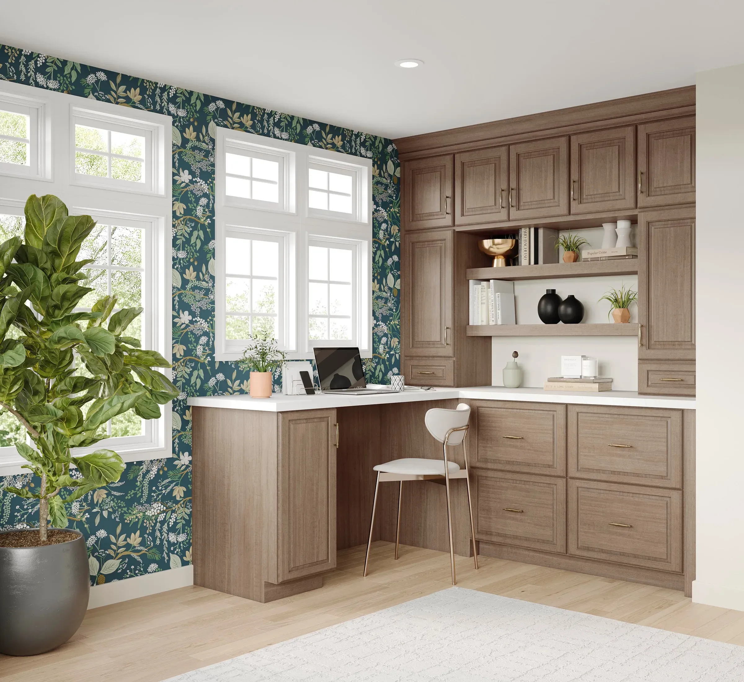 L-shaped desk run in almond maple with open shelving and upper cabinets against botanical wallpaper.